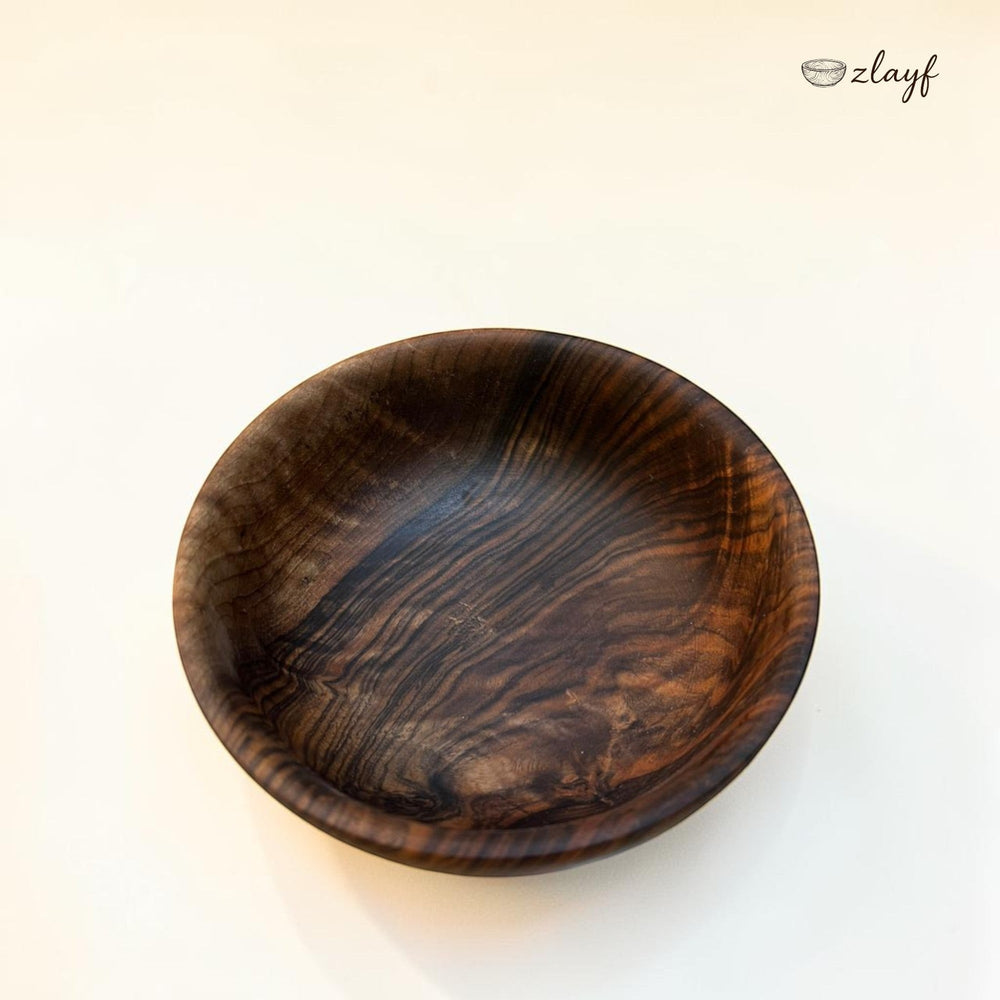 Zlayf hand carved dark walnut wooden serving bowl with natural grain patterns and smooth polished finish.