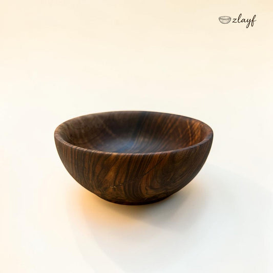 Zlayf hand carved dark walnut wooden serving bowl with natural grain patterns and smooth polished finish.