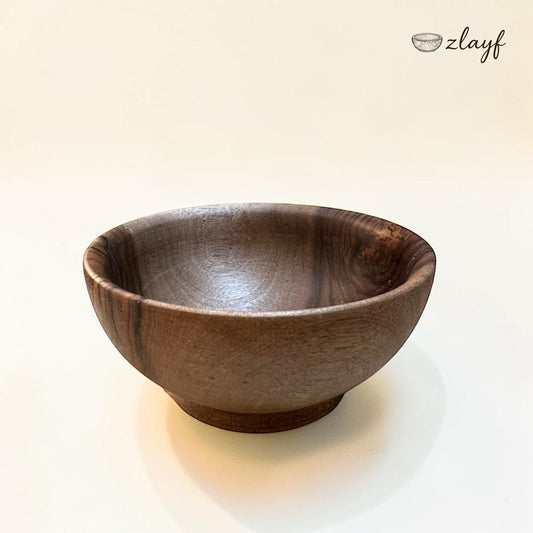 Zlayf handcrafted dark walnut wooden serving bowl with a smooth natural finish and unique grain patterns.