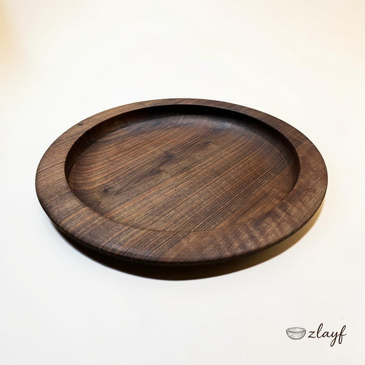 Zlayf hand carved dark walnut wooden serving tray with subtle carved rim and natural grain patterns.