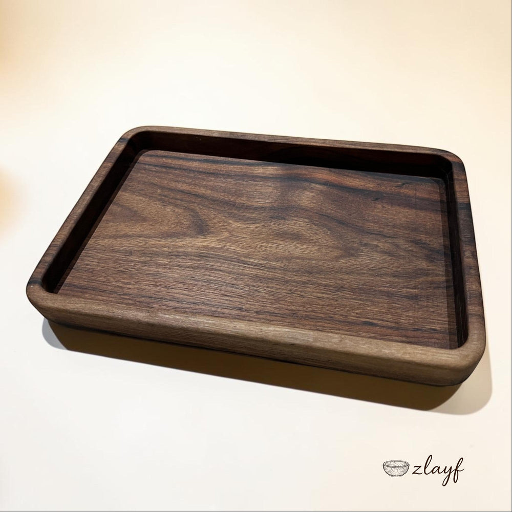 Zlayf rectangular walnut wood serving tray with rich dark tones and natural grain. Smooth rounded edges.