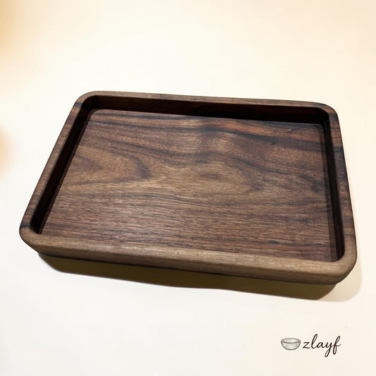 Zlayf rectangular walnut wood serving tray with raised edges and natural grain patterns.